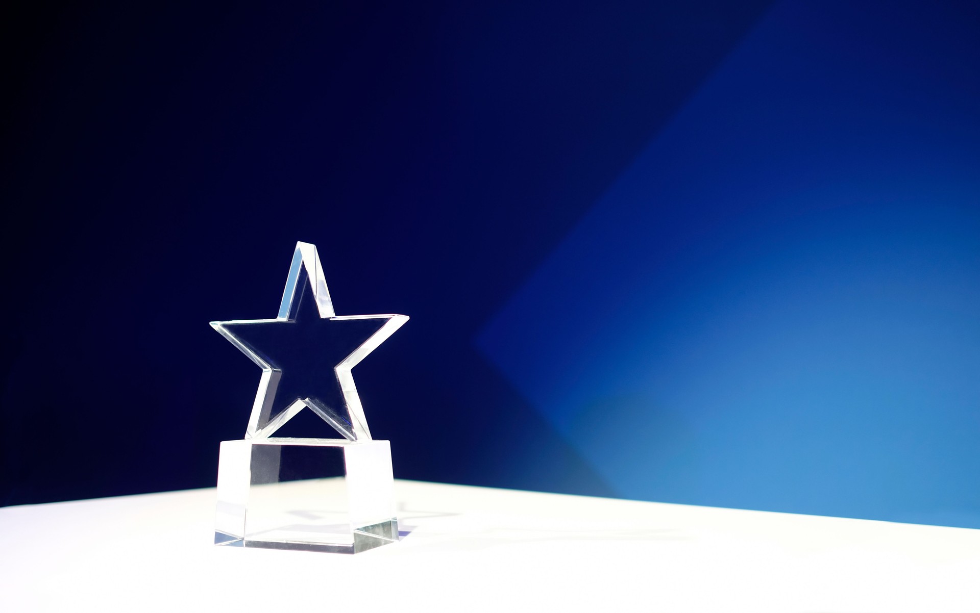 Award on a table with spotlights and copy space
